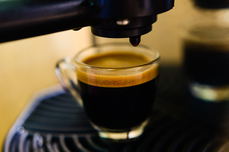 coffee machine preparing cup of coffee (espresso)の写真素材