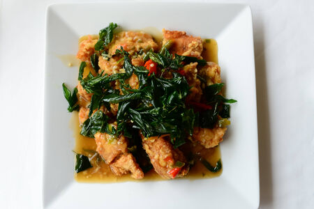 Spicy fried chicken with basil leavesの写真素材