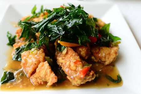 Spicy fried chicken with basil leavesの写真素材