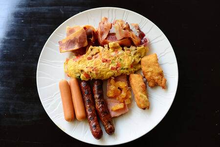 Full breakfast with omlette sausage bacon and fried   potatoの写真素材