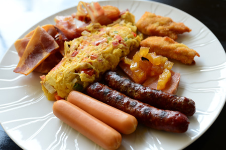 Full breakfast with omlette sausage bacon and fried   potatoの写真素材