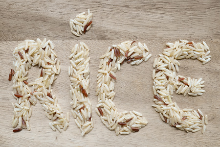 Rice letter on wood table.の写真素材