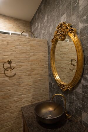 Gold mirror in bathroom.の写真素材