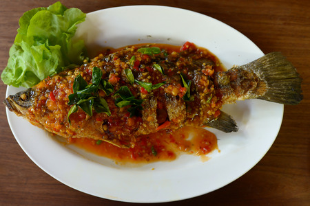 Fried Grouper fish with spicy sauce.の写真素材