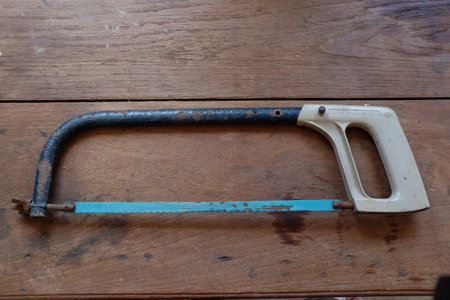 Hand saw on wooden background.の写真素材