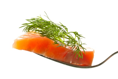 a piece of salted trout on a fork over white backgroundの写真素材