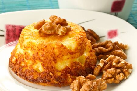 cheese muffins with walnuts on a plate with teaの写真素材