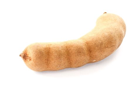 fresh tamarind in the shell on a white backgroundの写真素材