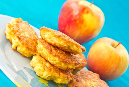 apple pancakes, fresh apples on a blue backgroundの写真素材