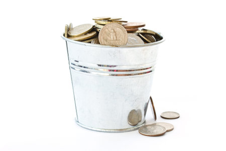 a full bucket of coins on white background