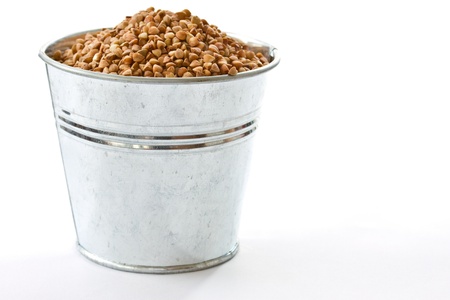 Buckwheat in a bucket on a white backgroundの写真素材