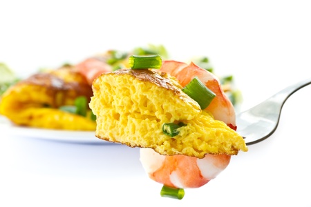 omelet with cooked shrimp and greens on a white backgroundの写真素材