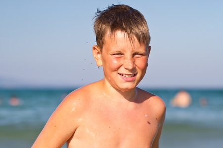 happy tanned boy in the summer seaの写真素材