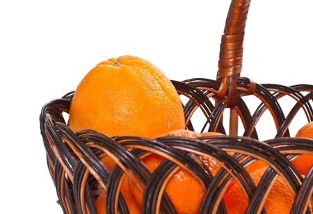 ripe juicy orange fruit in a basket on a white backgroundの写真素材