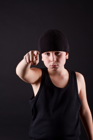 boy in a black cap and a black T-shirt points the fingerの写真素材