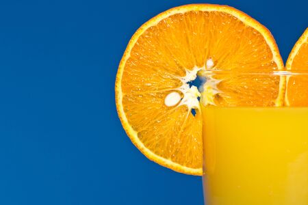 fresh sweet tangerine juice on a blue backgroundの写真素材