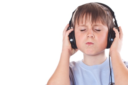 Boy listening to music with headphones on white backgroundの写真素材