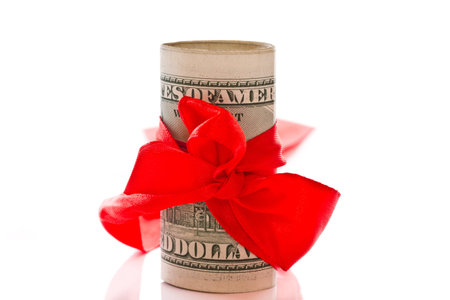 dollars tied bow as a gift on a white backgroundの写真素材