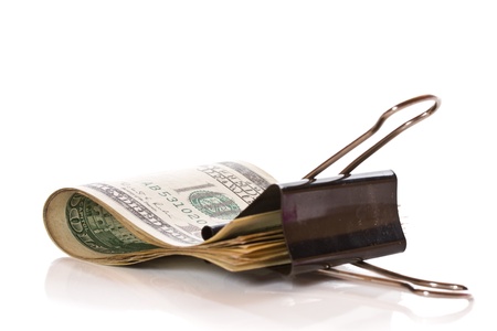 dollars caught in the paper clip on a white backgroundの写真素材