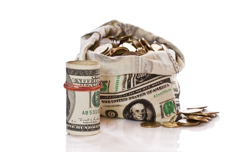 Dollars and coins in money bag on a white backgroundの写真素材