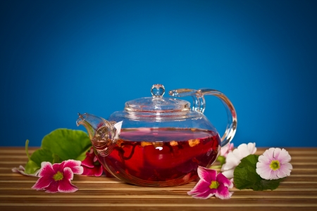 flower tea in a pot on a blue backgroundの写真素材