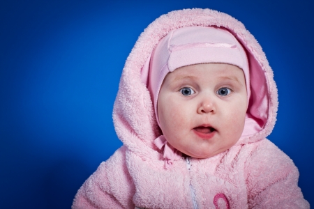 pretty little girl on a blue backgroundの写真素材