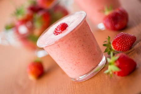 strawberry smoothie with strawberries in pots on a wooden tableの写真素材