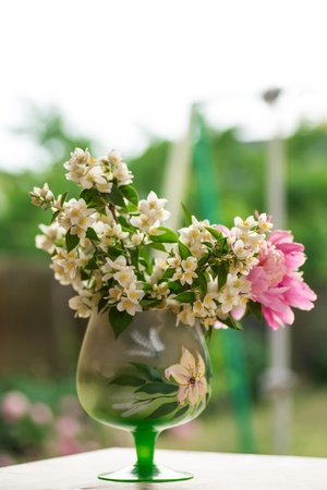 jasmine bouquet with pink peonies on a green backgroundの写真素材