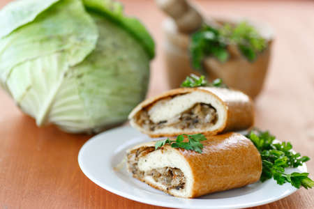 pie with cabbage and mushrooms on a plateの写真素材