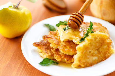 pancakes with quince on a plate with mintの写真素材