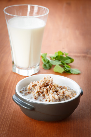boiled buckwheat porridge with milk in a bowlの写真素材