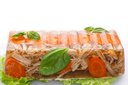 jellied meat with carrots garnished with vegetablesの写真素材