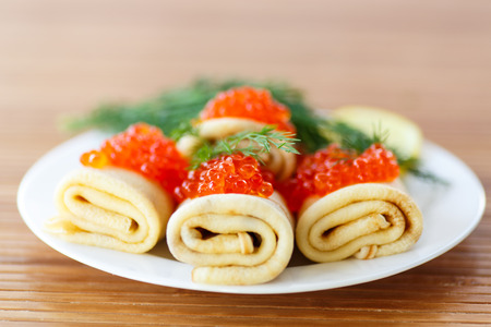 pancakes with red caviar on a plateの写真素材