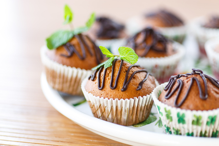 muffins with chocolate and nuts decorated with mintの写真素材
