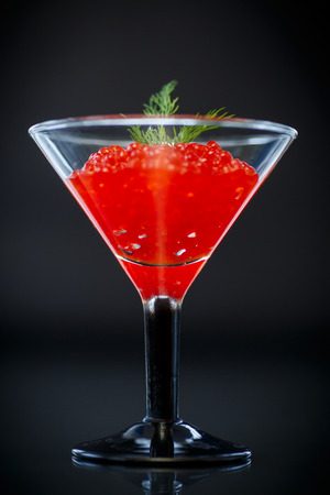 red caviar in a glass on a black の写真素材