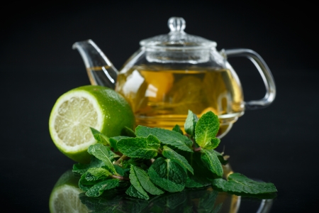 tea with lemon and mint on black backgroundの写真素材