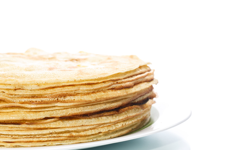 many thin pancakes on a white backgroundの写真素材