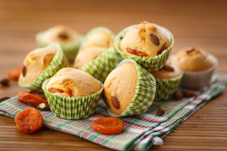 muffins with almonds and apricots on the tableの写真素材