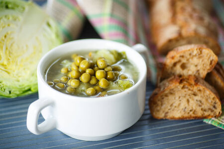 pea soup with cabbage and vegetables on the tableの写真素材