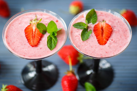 strawberry smoothie with mint in glasses on the tableの写真素材