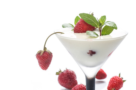milk with strawberry jelly in glasses on white backgroundの写真素材