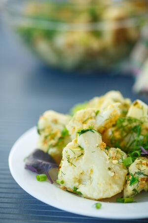 fried cauliflower with herbs on a plateの写真素材