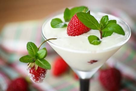 milk with strawberry jelly in glasses on a wooden tableの写真素材
