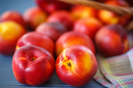 Ripe sweet nectarines on wooden table, close upの写真素材