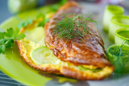 omelette with zucchini in a bowl on the tableの写真素材