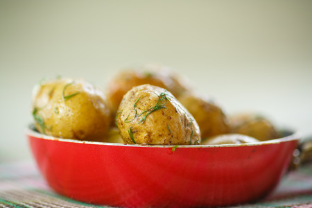 roasted new potatoes in a pan on the tableの写真素材
