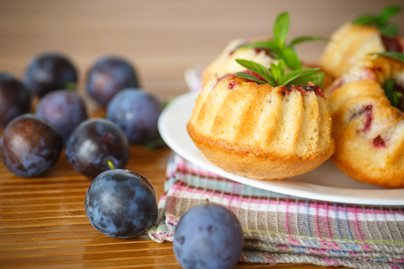 sweet plum muffins on a wooden tableの写真素材