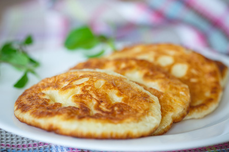 sweet pancakes with a sprig of mint on a plateの写真素材