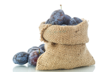 ripe plums in a bag on a white backgroundの写真素材