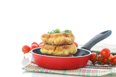 fried fish cutlets in the corn flour on a white background